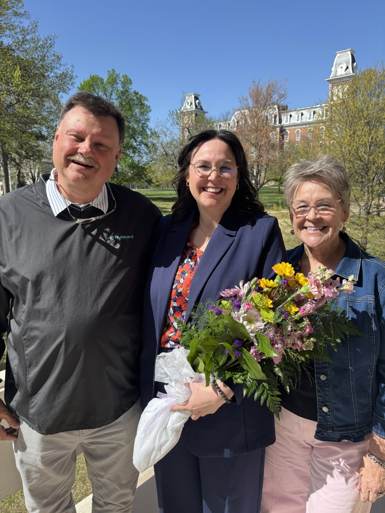 Kate with her parents after her dissertation defense